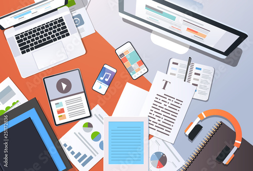 digital content management information technology concept top angle view desktop computer tablet laptop smartphone article text document office stuff horizontal