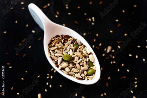 Sesame seeds next to different fruit seeds