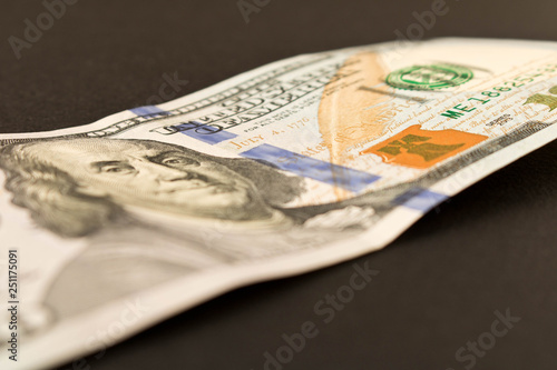 100 dollar bill. Isolated on black background. Selective focus.