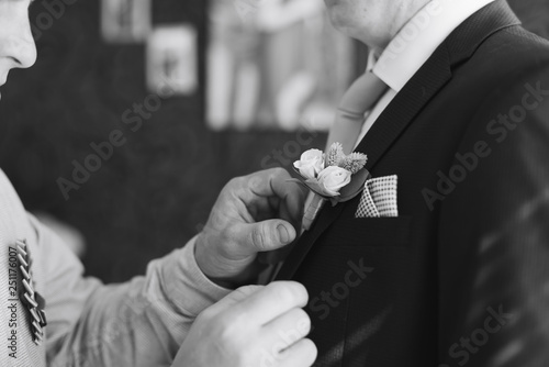 the morning of the groom, a handsome guy in a suit with a bow tie