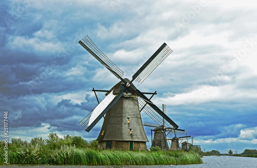 Kinderijk Molenwaard Netherlands..wind mill with river and green grass for wallpaper and postcard.