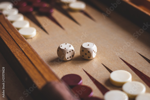 Foto Dice on backgammon board game. Selective focus