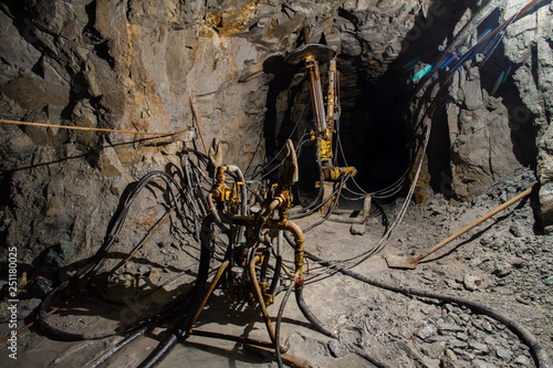 Underground gold ore mine shaft tunnel gallery passage with drilling machine