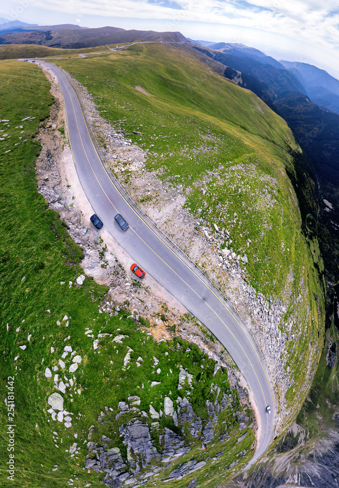 Aerial top down view on transalpina, cars on road on Romania mountain,  travel, adventure concept, motorcyclists way, vacation place, mountains  top, summer day, vertical photo Stock Photo | Adobe Stock