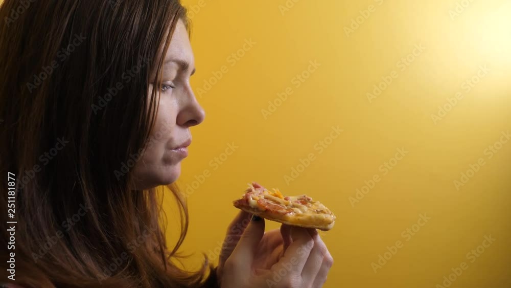 Piece Pizza . happy girl eating a slice of pizza concept lifestyle . woman hungry eats a slice of pizza. slow motion video. pizza fast food concept Piece Pizza . happy girl eating a slice of pizza concept lifestyle . woman hungry eats a slice of pizza. slow motion video. pizza fast food concept