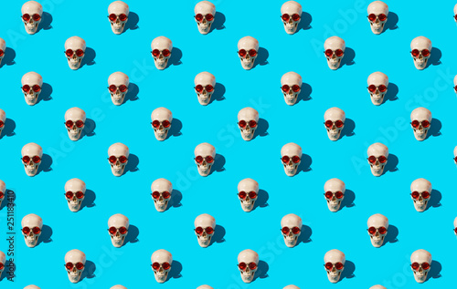 skull pattern with glasses on a blue background