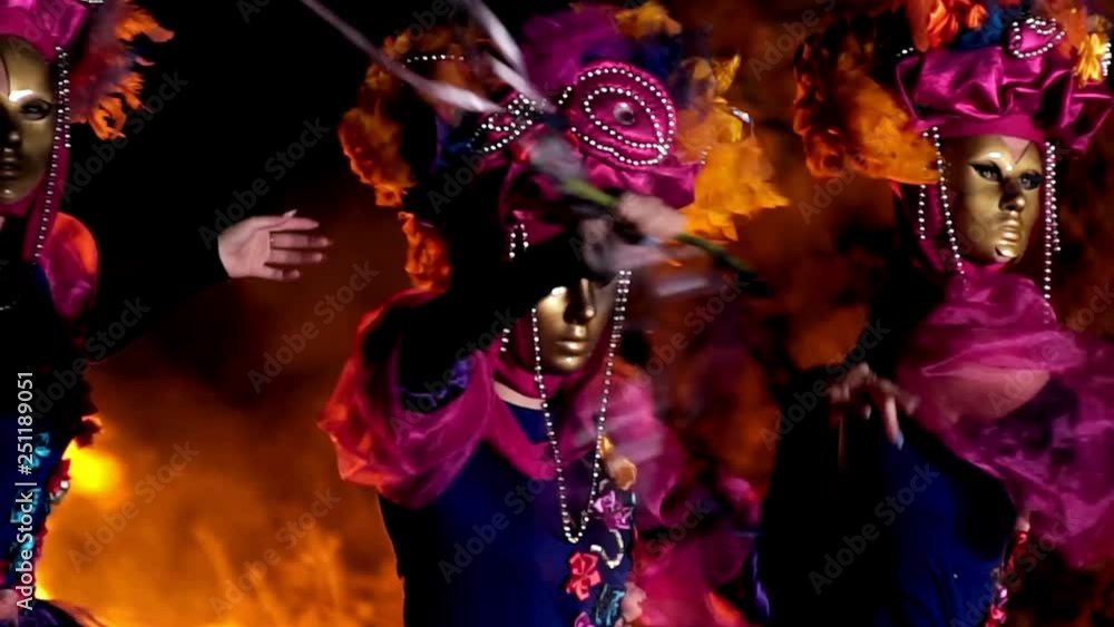 three girls in pink and purple dresses dancing and waving ribbons. three girls in pink and purple dresses dancing and waving ribbons.