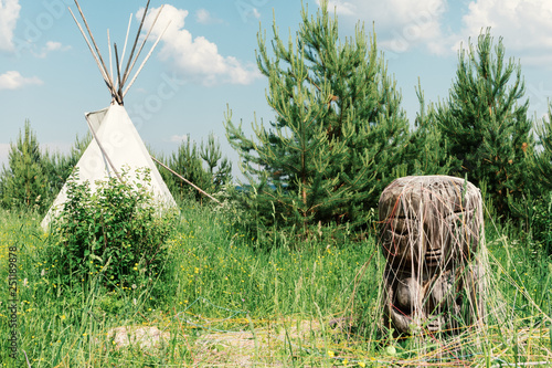 Ancient deity of earth and fertility of the Pachamama in the backdrop of the Indian wigwam. photo