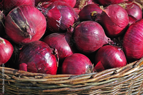 red onions in a wicker basket