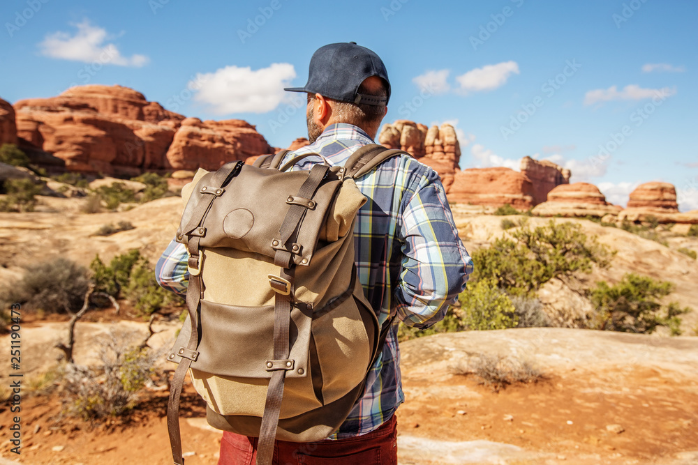 Hiker in Canyonlands National park, needles in the sky, in Utah, USA Hiker in Canyonlands National park, needles in the sky, in Utah, USA