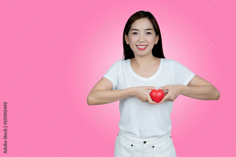 Asian women hand holding red heart in smiley face. Show healthy. Strong heart condition. No complications such coronary artery disease. Be sure to check the body. And health insurance to reduce costs. Asian women hand holding red heart in smiley face. Show healthy. Strong heart condition. No complications such coronary artery disease. Be sure to check the body. And health insurance to reduce costs.