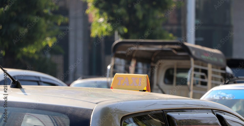 Taxi light sign or cab sign in yellow color on the car roof.