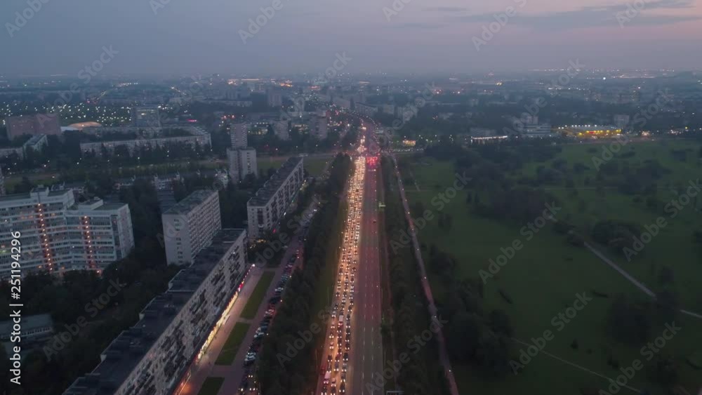 Aerial view of evening traffic of Saint Peterburg city. Drone flight over road traffic in rush hour. car headlights. The tube in the direction of residential areas Aerial view of evening traffic of Saint Peterburg city. Drone flight over road traffic in rush hour. car headlights. The tube in the direction of residential areas