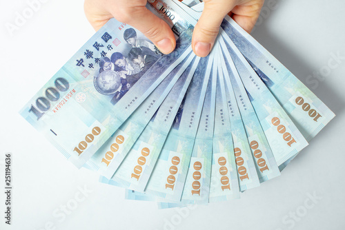 Human hands holding money isolated on white background. Giving money concept.  photo