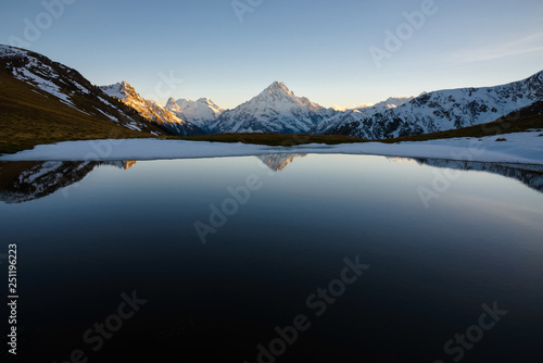 Lake in the mountains at sunset in the cold season. Copy space for text