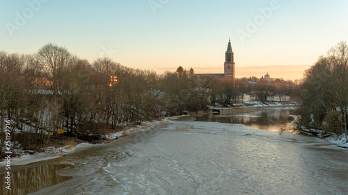 Sunset view to the icy Aurajoki river in Turku, Finland. February 2019.