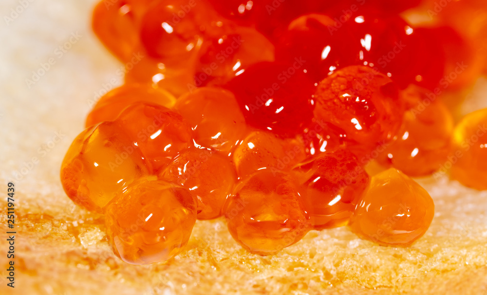 Red caviar on bread as a background Red caviar on bread as a background