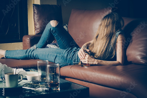 Tableau sur toile Young drunk woman on the sofa