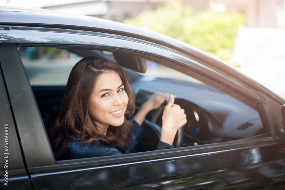 Naklejka premium Beautiful woman is driving her car