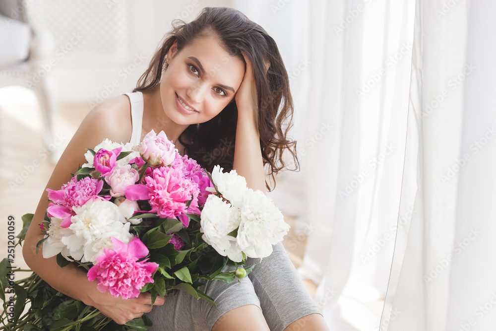 Close up portrait of young beautiful woman with flowers indoors Close up portrait of young beautiful woman with flowers indoors