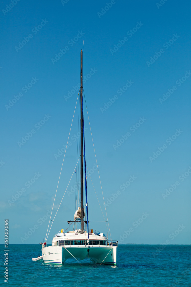Yacht - Catamaran in the tropical sea. Yachting Luxury Sailing. Yacht - Catamaran in the tropical sea. Yachting Luxury Sailing.