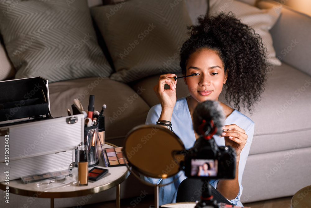 Beauty vlogger applying cosmetics on her eye