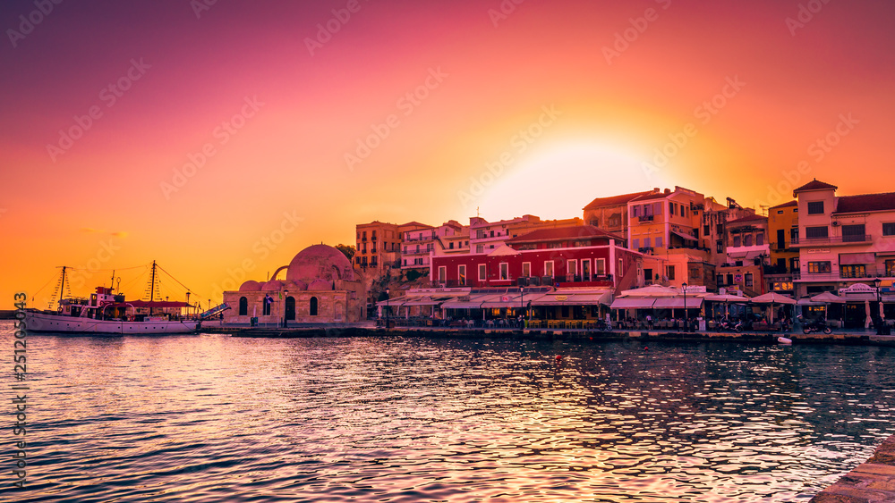 CHANIA, CRETE ISLAND, GREECE - JUNE 26, 2016: Stunning sunset view of the old venetian port of Chania on Crete island, Greece.
