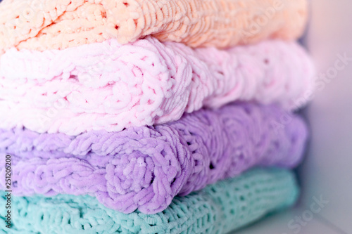 A few bright colored knitting needles bedspreads or blankets. Comfort, homely warmth. Selective focus.