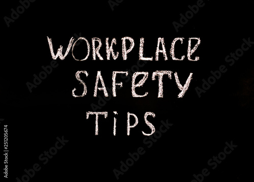 Black background with the inscription workplace safety tips . Safety concept.