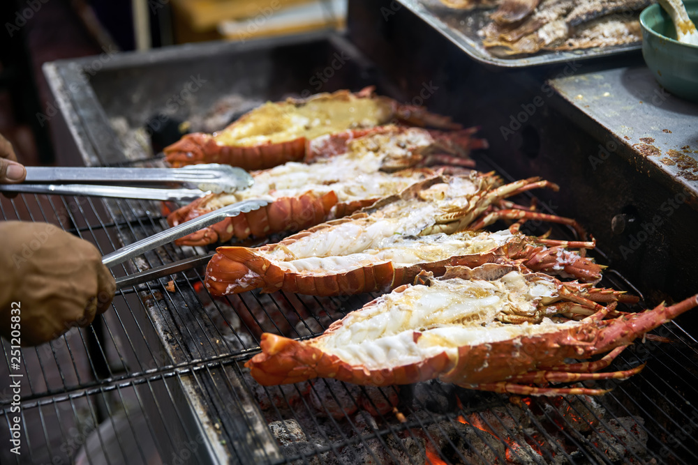 Grilled lobsters on street food market in Thailand