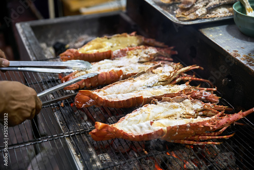 Photography Grilled lobsters on street food market in Thailand