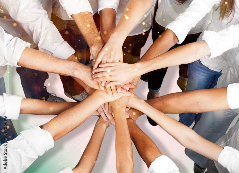 Group of people stacking hands together Group of people stacking hands together