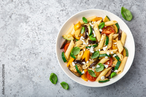 Photo pasta salad with grilled vegetables ( zucchini, eggplant, bell pepper ant tomato