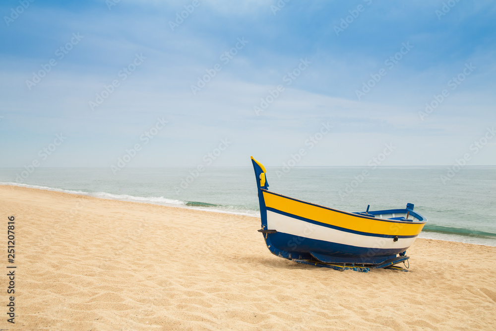 Wooden fishing boat on a sandy beach