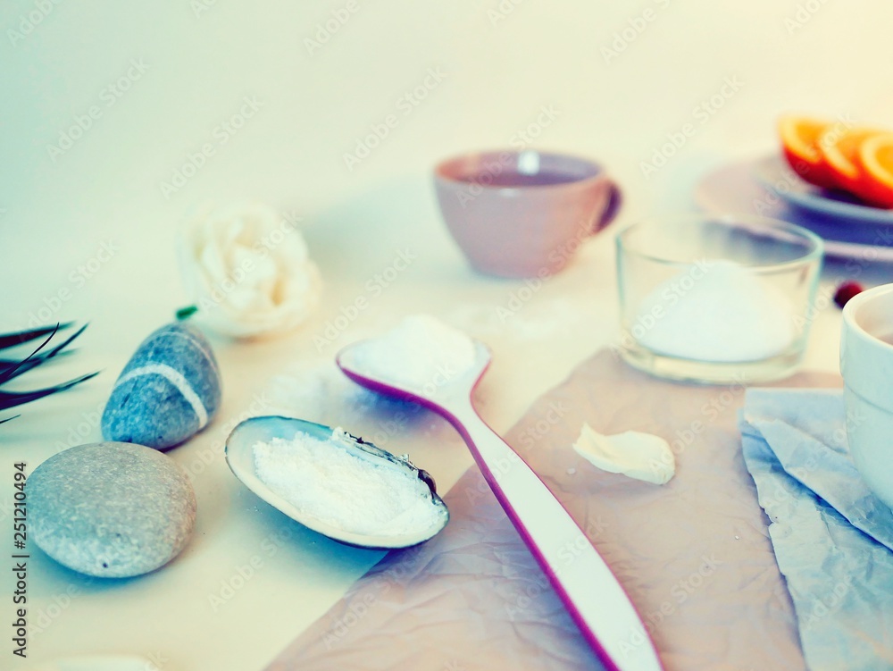Sea salt, sliced orange, sea stones and shells, water on a bright table, ingredients for a mask, scrub, gentle care procedures Sea salt, sliced orange, sea stones and shells, water on a bright table, ingredients for a mask, scrub, gentle care procedures