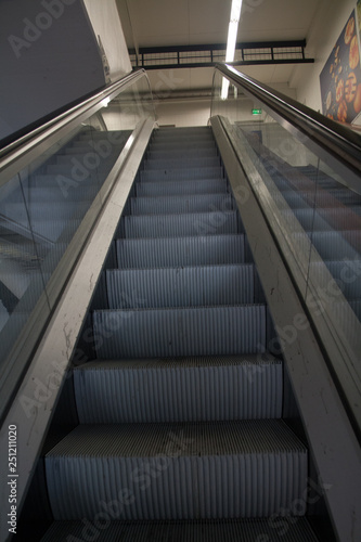 Empty modern escalator in interior of shopping center.