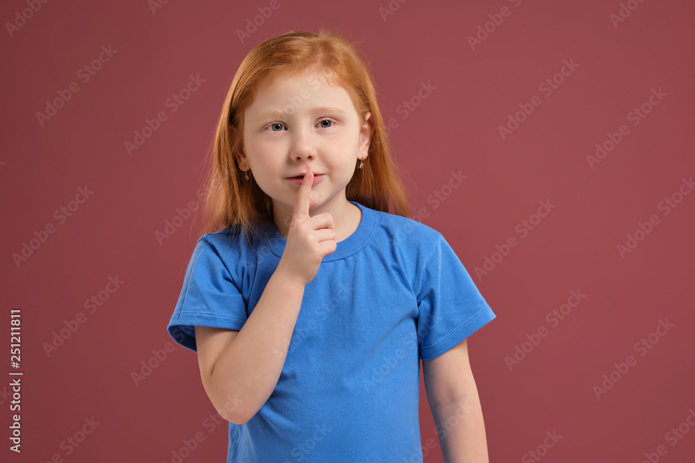 Portrait of cute redhead emotional little girl on red background Portrait of cute redhead emotional little girl on red background