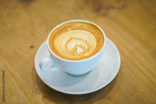 Cups of latte art on wooden table background, Top view.