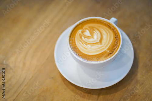 Cups of hot latte art on wooden table background, Top view.