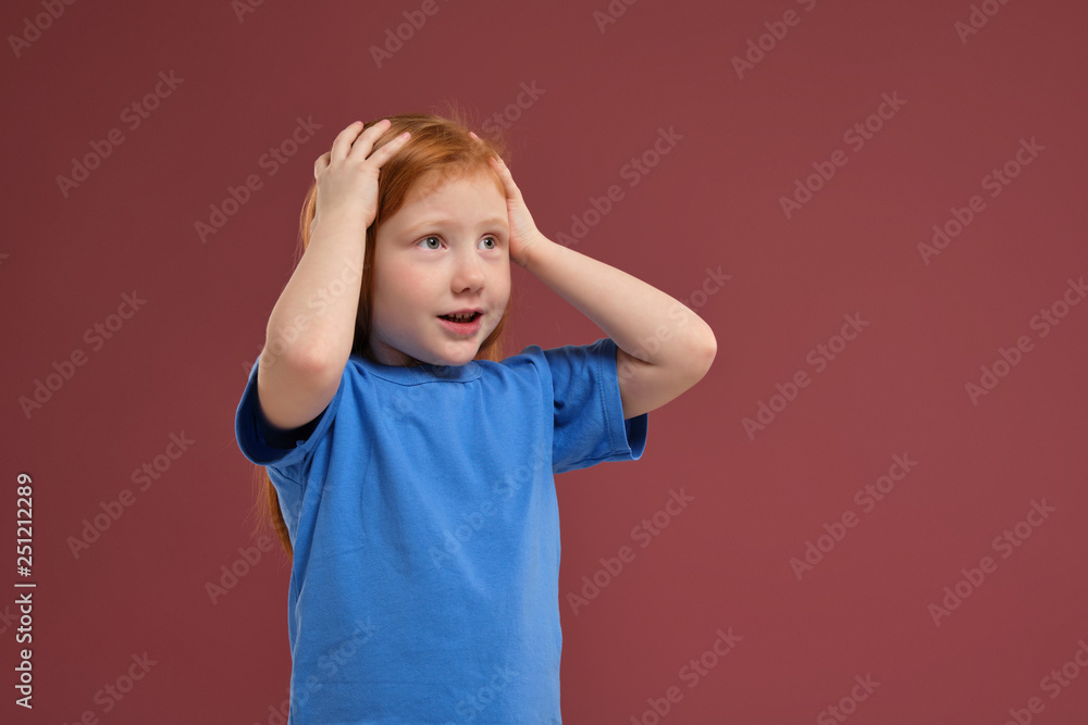 Portrait of cute redhead emotional little girl on red background Portrait of cute redhead emotional little girl on red background