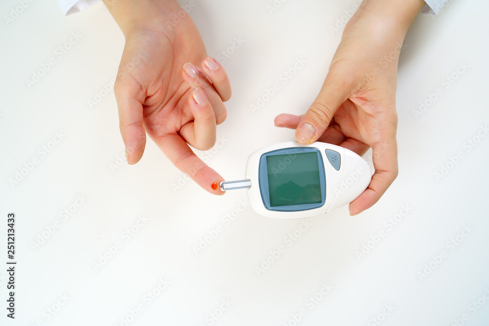 Photo of woman's hand with glucometer. Photo of woman's hand with glucometer.