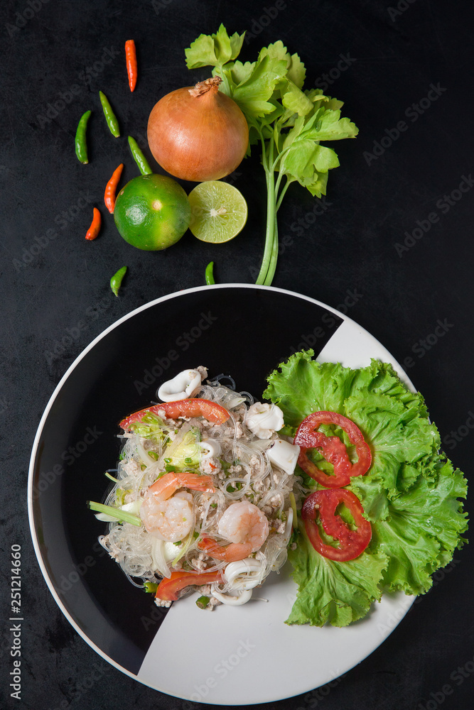 Glass Noodle,Pork, shrimp Spicy Salad on black and white dish