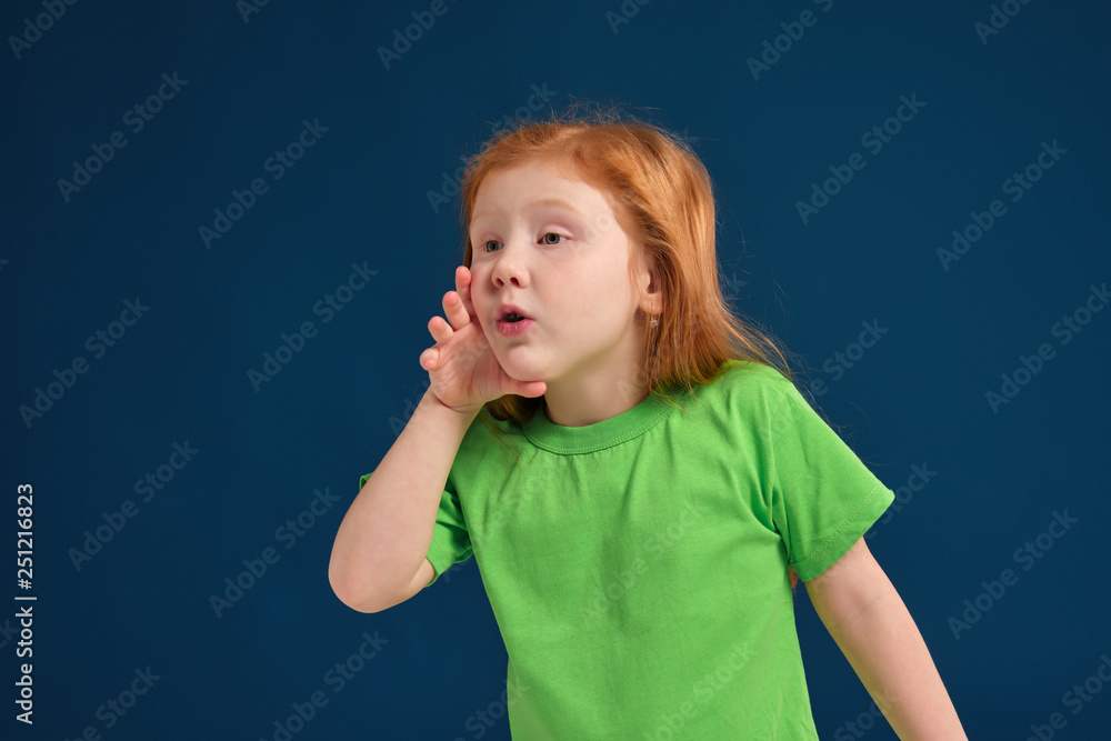 close up photo of little redhead emotional girl posing before camera on blue background close up photo of little redhead emotional girl posing before camera on blue background