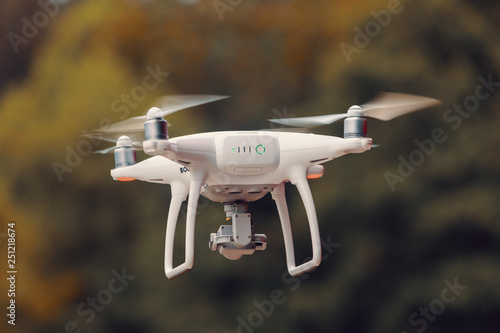 drone quad copter with high resolution digital camera against natural bokeh background