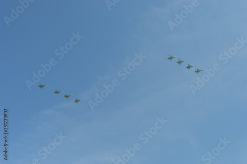 flock of birds flying in blue sky with clouds