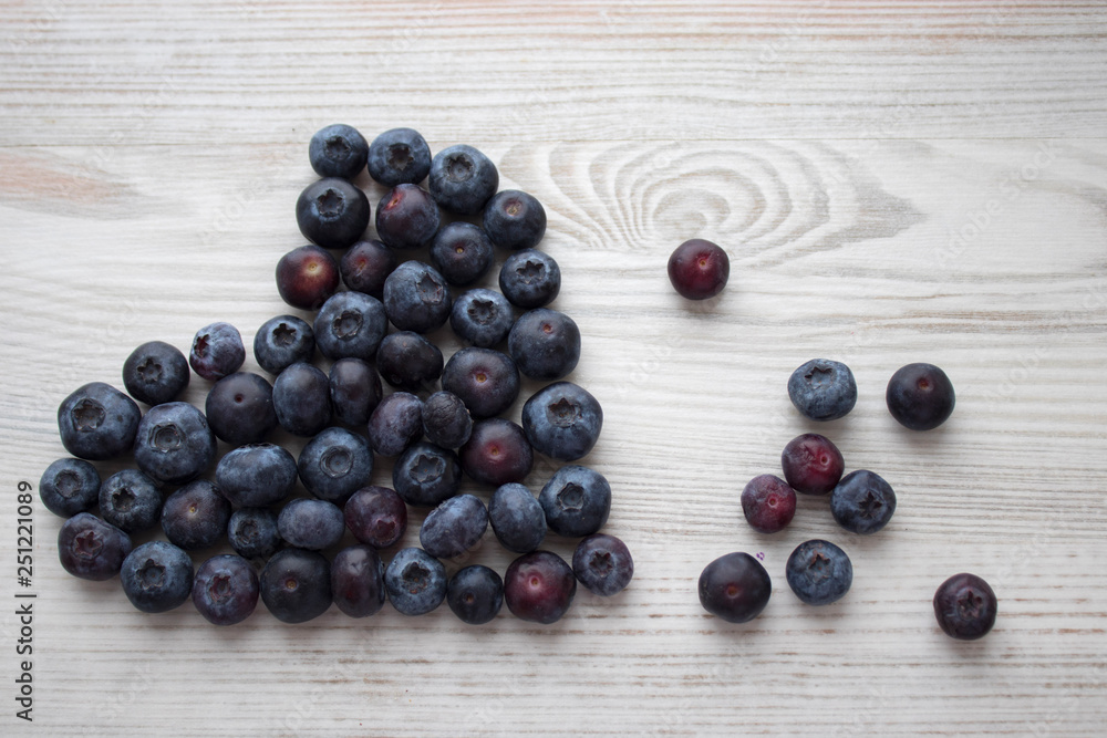 Fresh blueberry on wood background shape heart Fresh blueberry on wood background shape heart