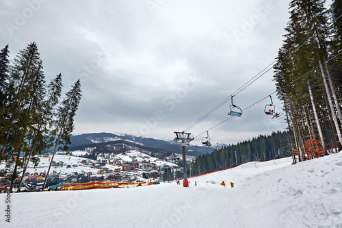 Ski lift at ski resort Bukovel in the mountains on a sunny winter day.