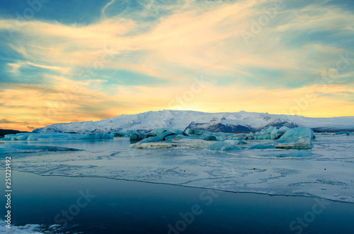 Frozen wonderland in scenic Iceland, with sun peaking over snowy Mountain © JMP Traveler
