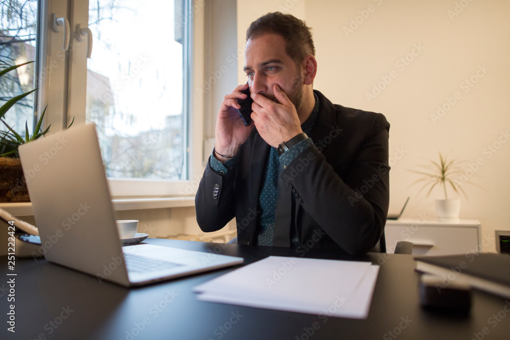businessman working on laptop in office making phone call nervous and angry businessman working on laptop in office making phone call nervous and angry
