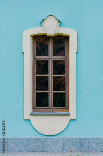 Closeup photo of modern window on bright blue wall